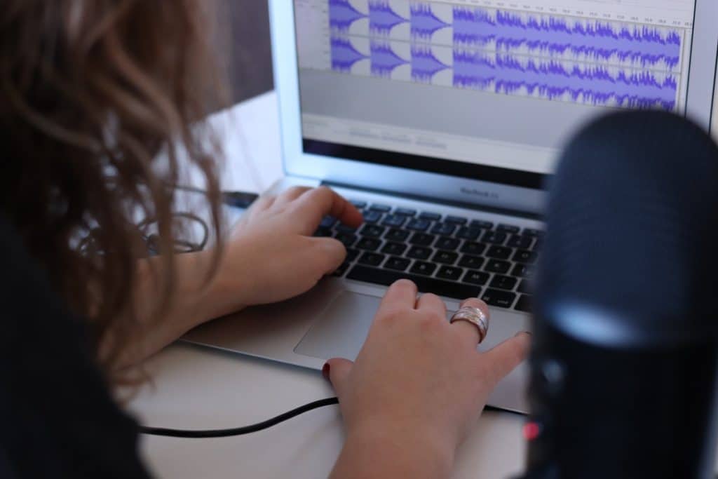 picture of podcaster editing their podcast using editing software