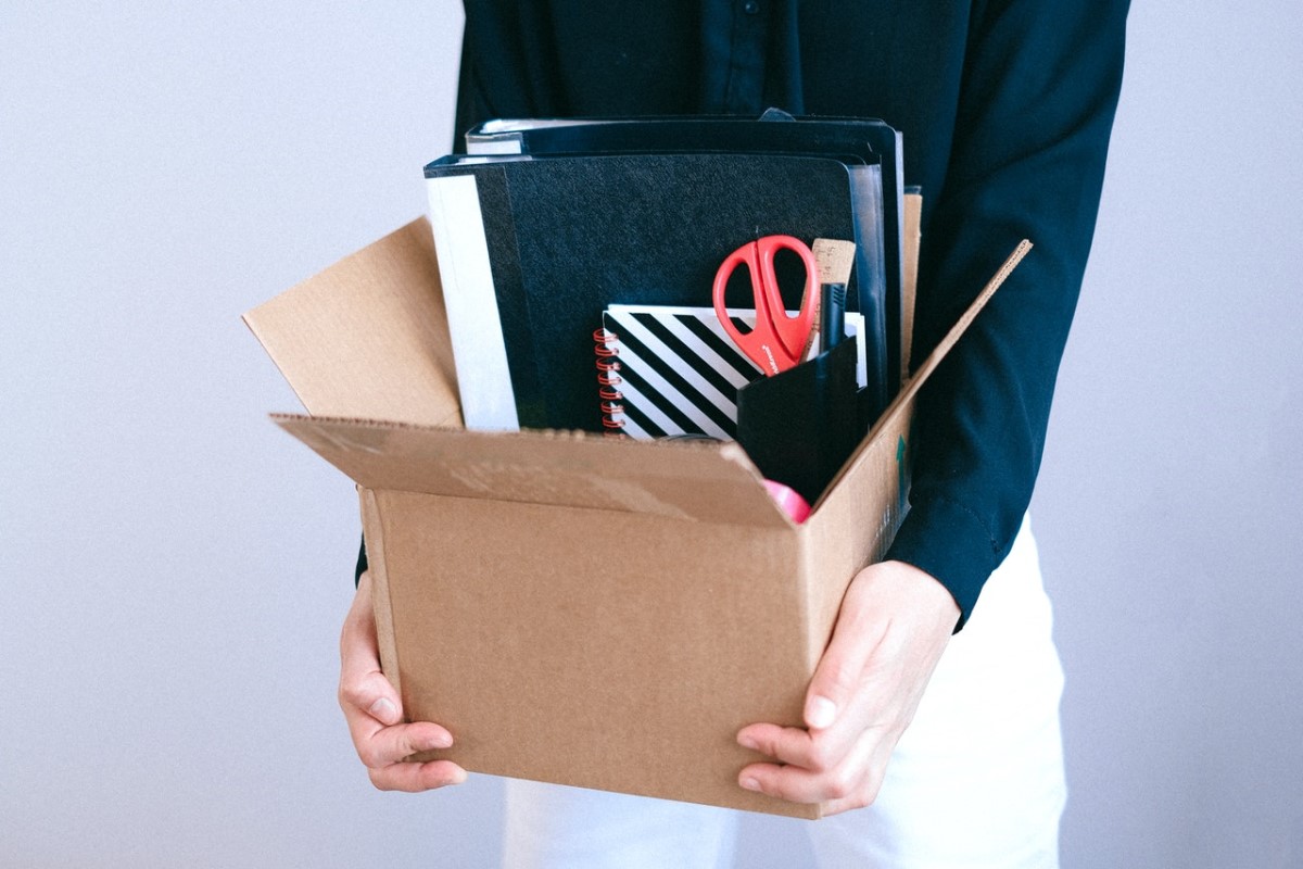 girl holding box of work supplies